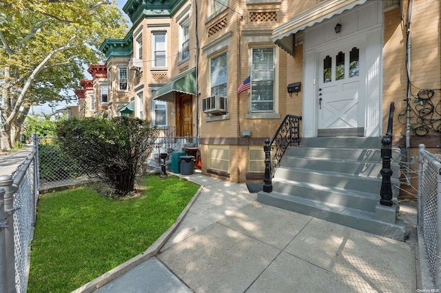 entrance to property featuring cooling unit