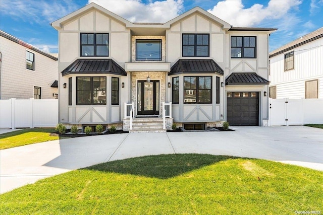 view of front of home with a garage and a front lawn