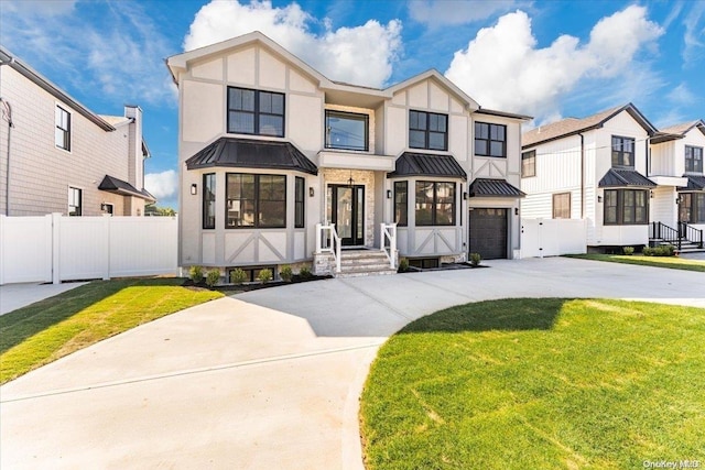 view of front of property with a front lawn and a garage