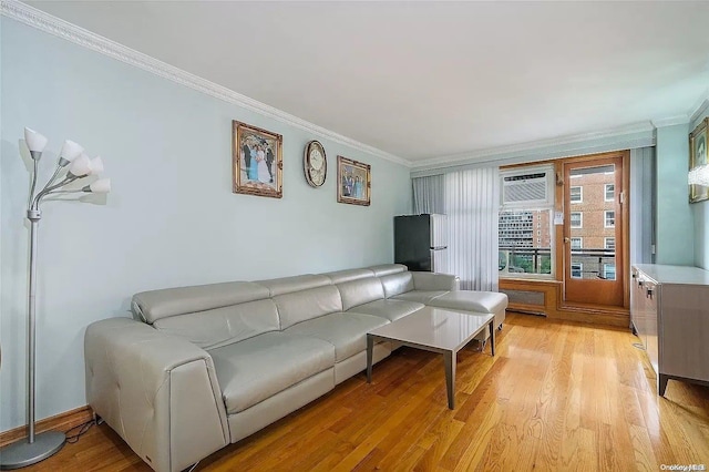 living room featuring ornamental molding, a wall unit AC, and light hardwood / wood-style flooring