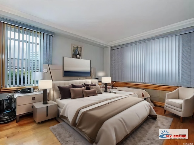 bedroom featuring light wood-type flooring and ornamental molding