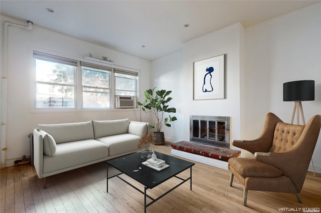 living room featuring cooling unit and light wood-type flooring