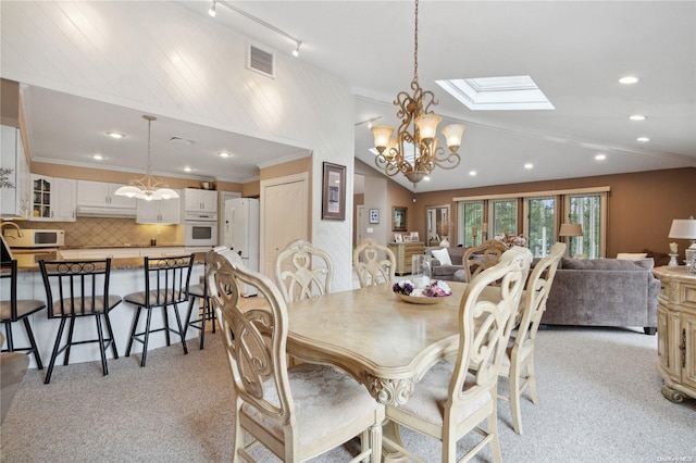 dining room featuring crown molding, light colored carpet, and a notable chandelier