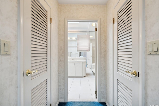 hallway with sink and light tile patterned floors