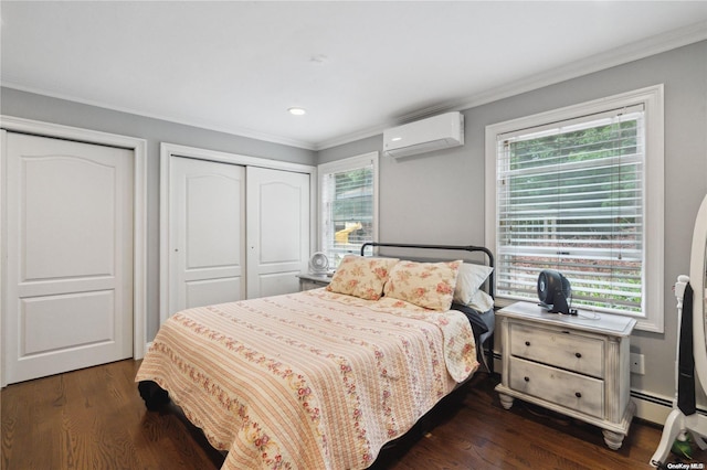 bedroom featuring multiple windows, dark hardwood / wood-style floors, and a wall mounted AC