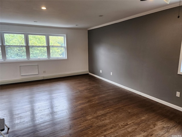 spare room with ceiling fan, crown molding, baseboard heating, and dark wood-type flooring