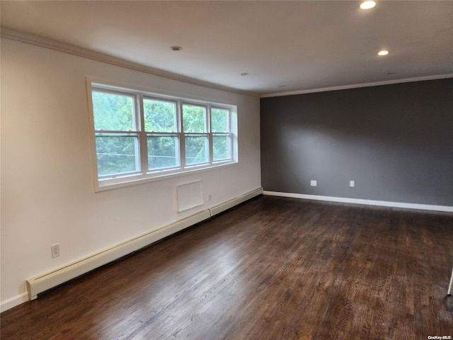 empty room with crown molding, dark hardwood / wood-style flooring, and a baseboard heating unit