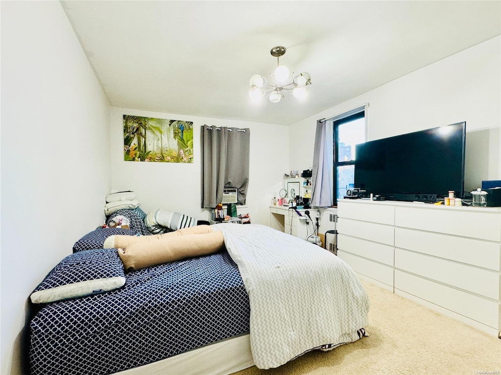 bedroom with a notable chandelier and carpet floors