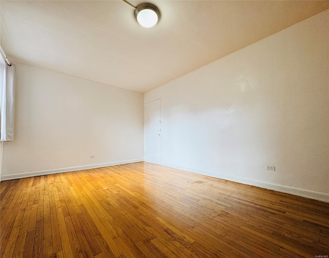 empty room featuring light wood-style floors and baseboards