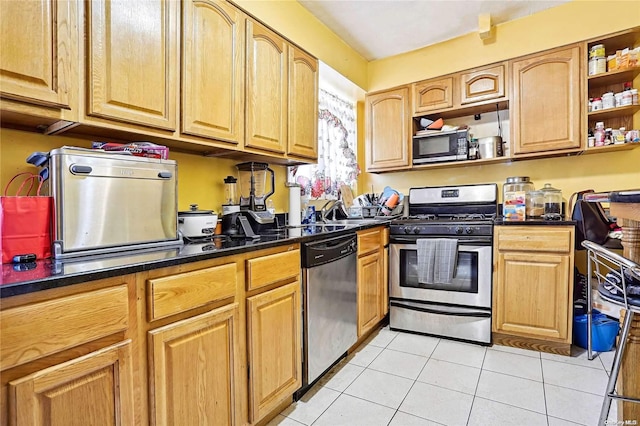 kitchen with light tile patterned floors and stainless steel appliances