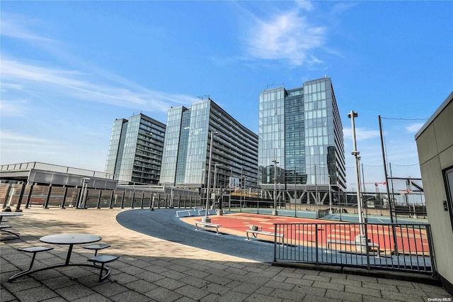 view of home's community with tennis court