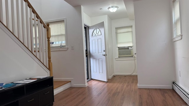 entryway featuring cooling unit, dark wood-type flooring, and a baseboard radiator