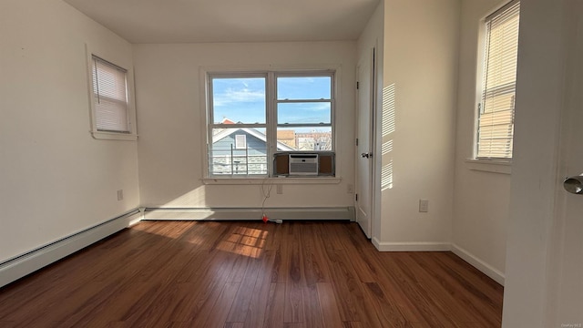 unfurnished room featuring dark hardwood / wood-style floors, a baseboard radiator, plenty of natural light, and cooling unit