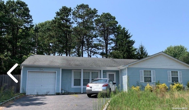 ranch-style home featuring a garage