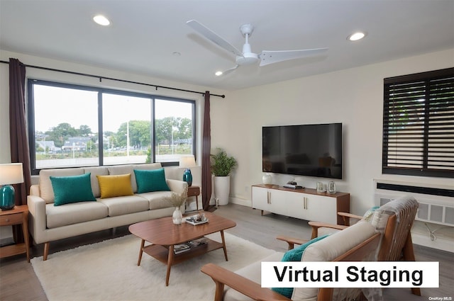 living room featuring ceiling fan and light wood-type flooring