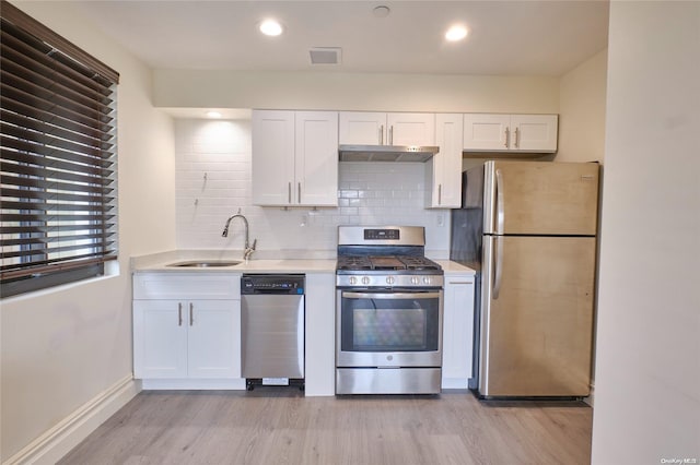 kitchen featuring white cabinets, stainless steel appliances, light hardwood / wood-style floors, and sink