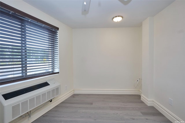 spare room with radiator heating unit and light hardwood / wood-style floors