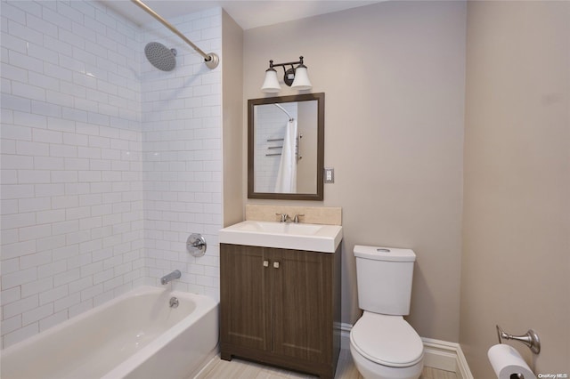 full bathroom featuring vanity, toilet, and tiled shower / bath