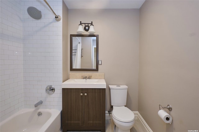 full bathroom featuring toilet, vanity, and tiled shower / bath