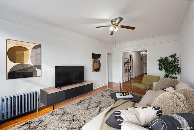 living room featuring ceiling fan, radiator heating unit, and wood-type flooring