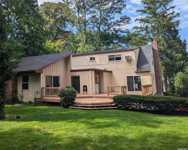 back of house featuring a lawn, a wooden deck, and a wall unit AC