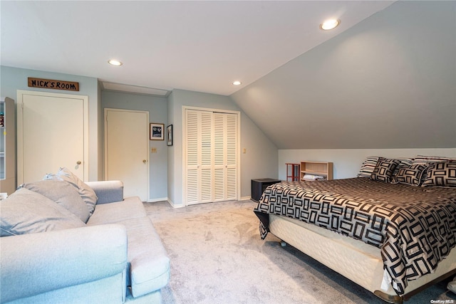 bedroom with light colored carpet and vaulted ceiling