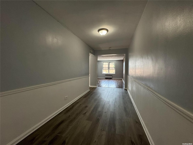 corridor with dark hardwood / wood-style floors