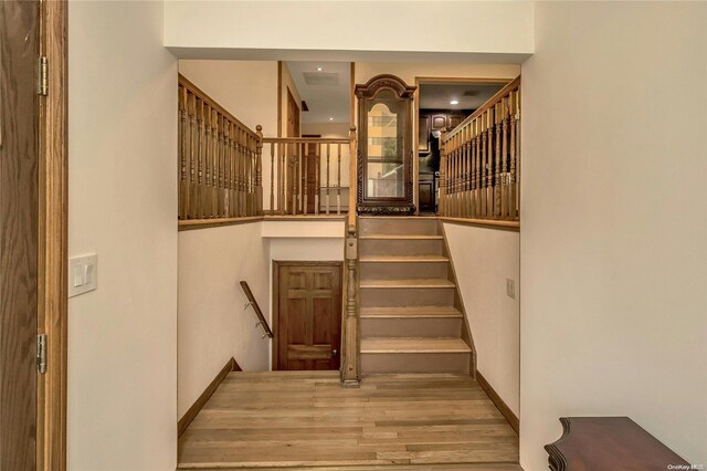 stairs featuring hardwood / wood-style floors