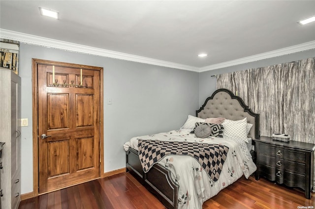 bedroom with dark hardwood / wood-style flooring and ornamental molding