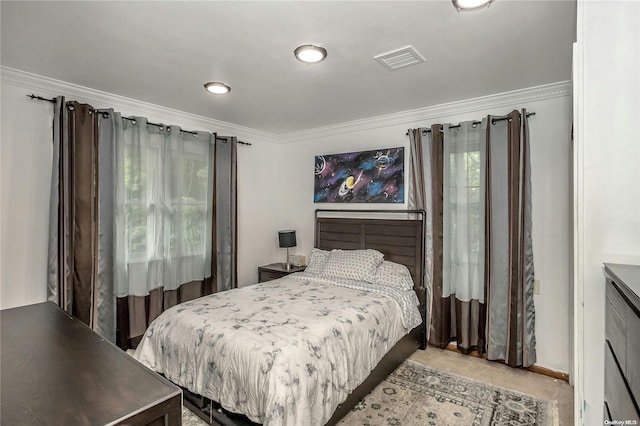 bedroom featuring crown molding and light carpet