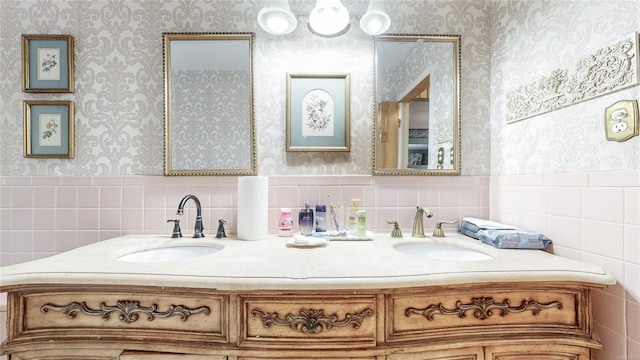 bathroom with vanity and tile walls