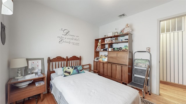 bedroom with hardwood / wood-style floors