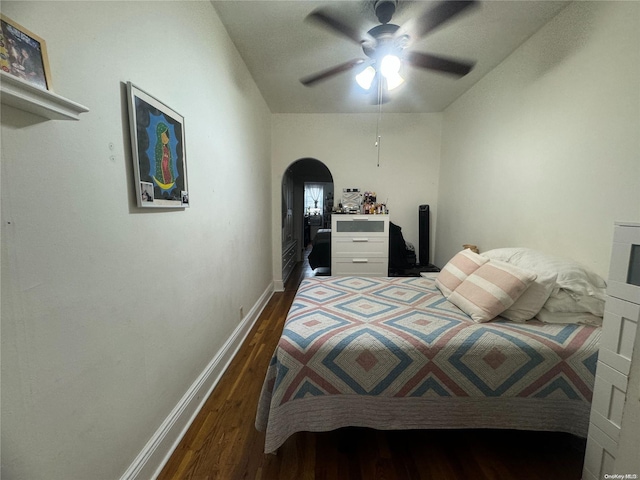 bedroom with ceiling fan and dark hardwood / wood-style floors