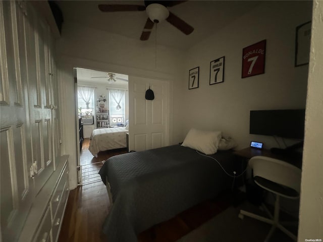 bedroom with ceiling fan, a closet, and dark wood-type flooring