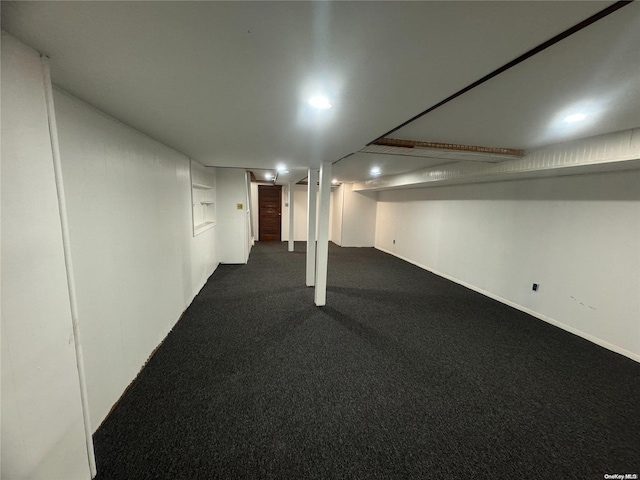 basement with dark colored carpet