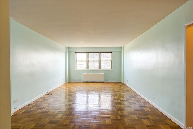 unfurnished room with dark parquet flooring