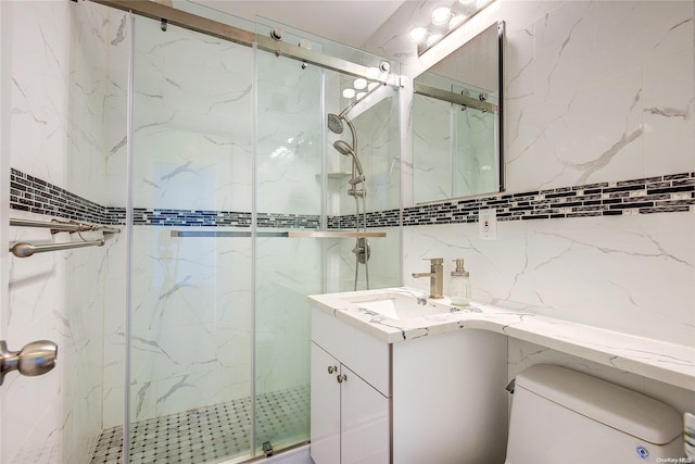 bathroom featuring vanity, toilet, and a shower with shower door