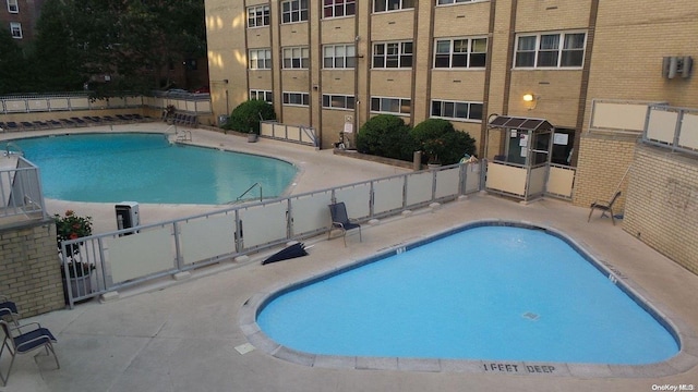 view of swimming pool featuring a patio area