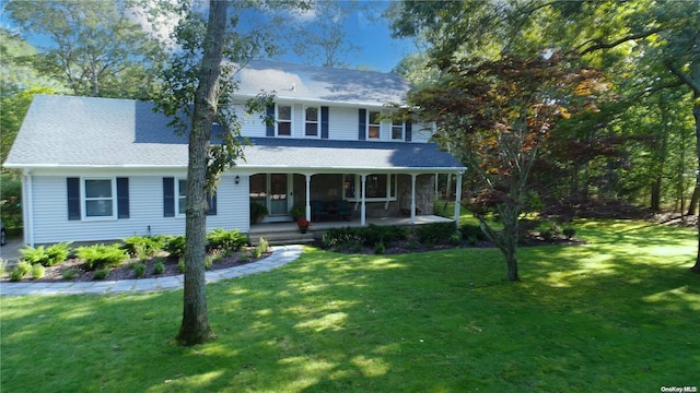 view of front facade with covered porch and a front yard