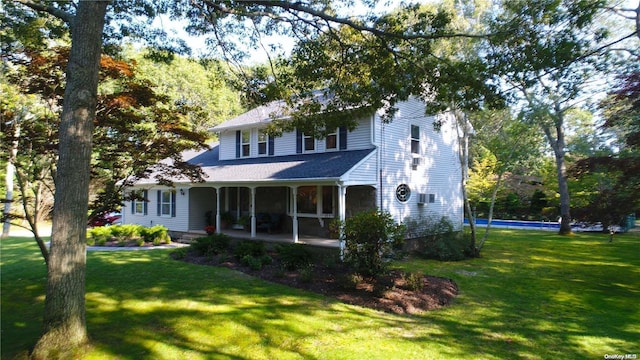 rear view of property featuring a yard