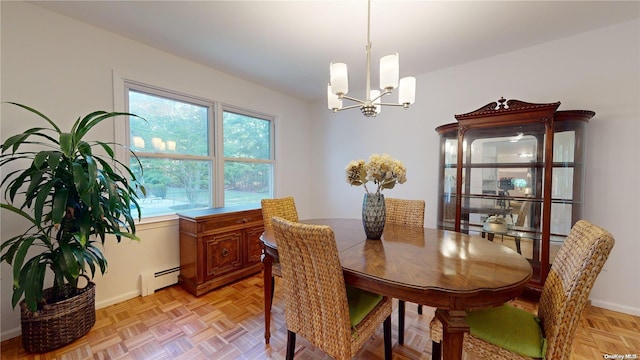 dining room featuring light parquet flooring, an inviting chandelier, and a baseboard heating unit