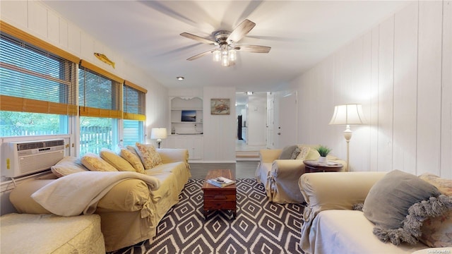 living room with hardwood / wood-style floors, ceiling fan, and cooling unit