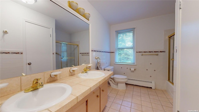 full bathroom featuring toilet, a baseboard radiator, tile patterned floors, and tile walls