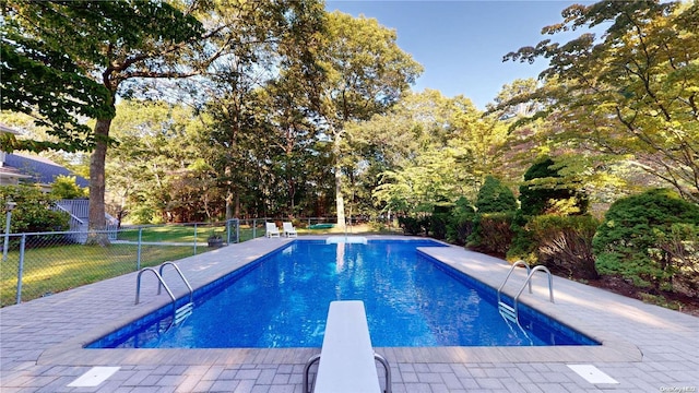 view of pool featuring a diving board