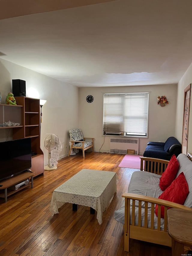 living room with wood-type flooring and radiator