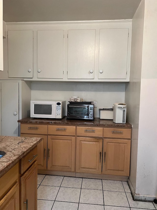 71-11 Yellowstone Blvd Unit 2D, Forest Hills, NY 11375 - kitchen featuring light tile patterned flooring and light stone countertops