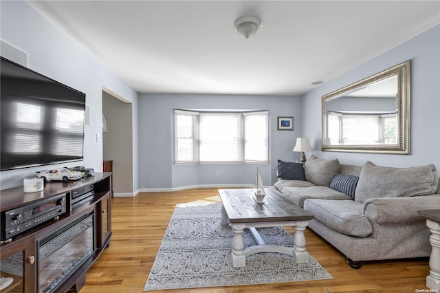 living room with plenty of natural light and light wood-type flooring