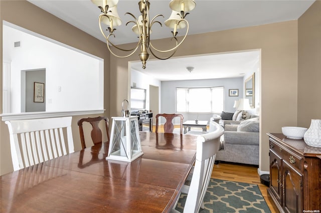 dining room featuring a chandelier and hardwood / wood-style floors