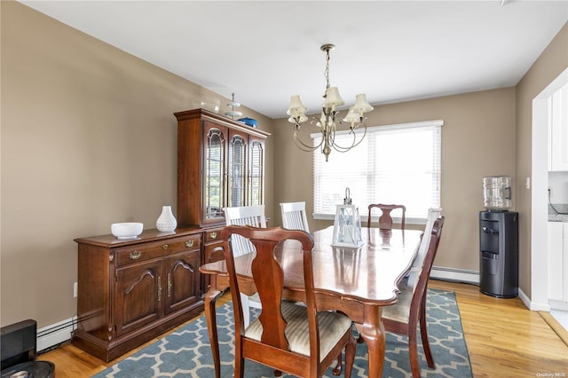 dining space with plenty of natural light, an inviting chandelier, a baseboard heating unit, and light wood-type flooring