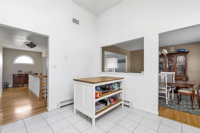 interior space featuring light wood-type flooring and a baseboard heating unit